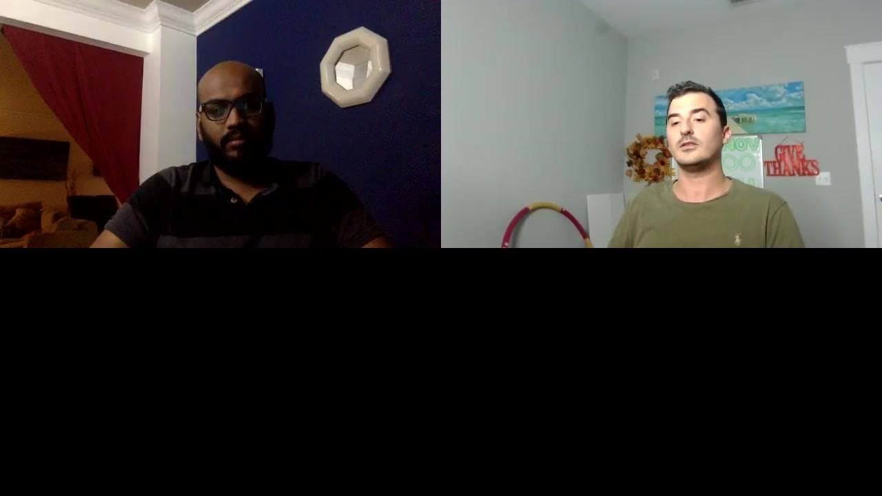 Split-screen video call between a bearded man in glasses and a man in olive seated beside a beach painting.