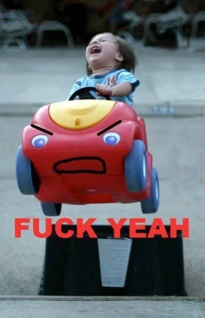 A toddler riding a red toy car with an angry face shouts with head thrown back; caption reads "FUCK YEAH."